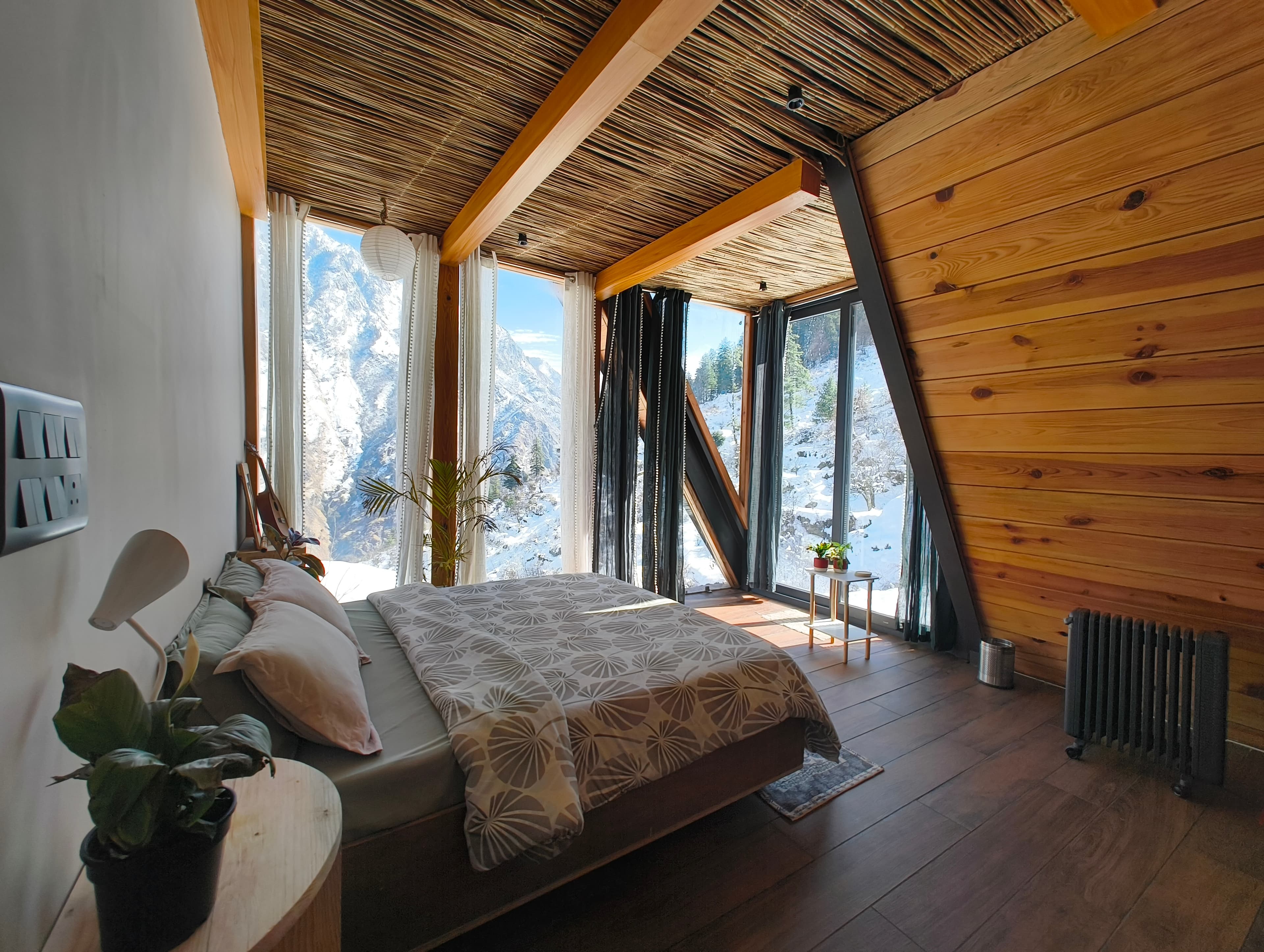 Forest View room interior — warm wood A-frame with floor-to-ceiling mountain views