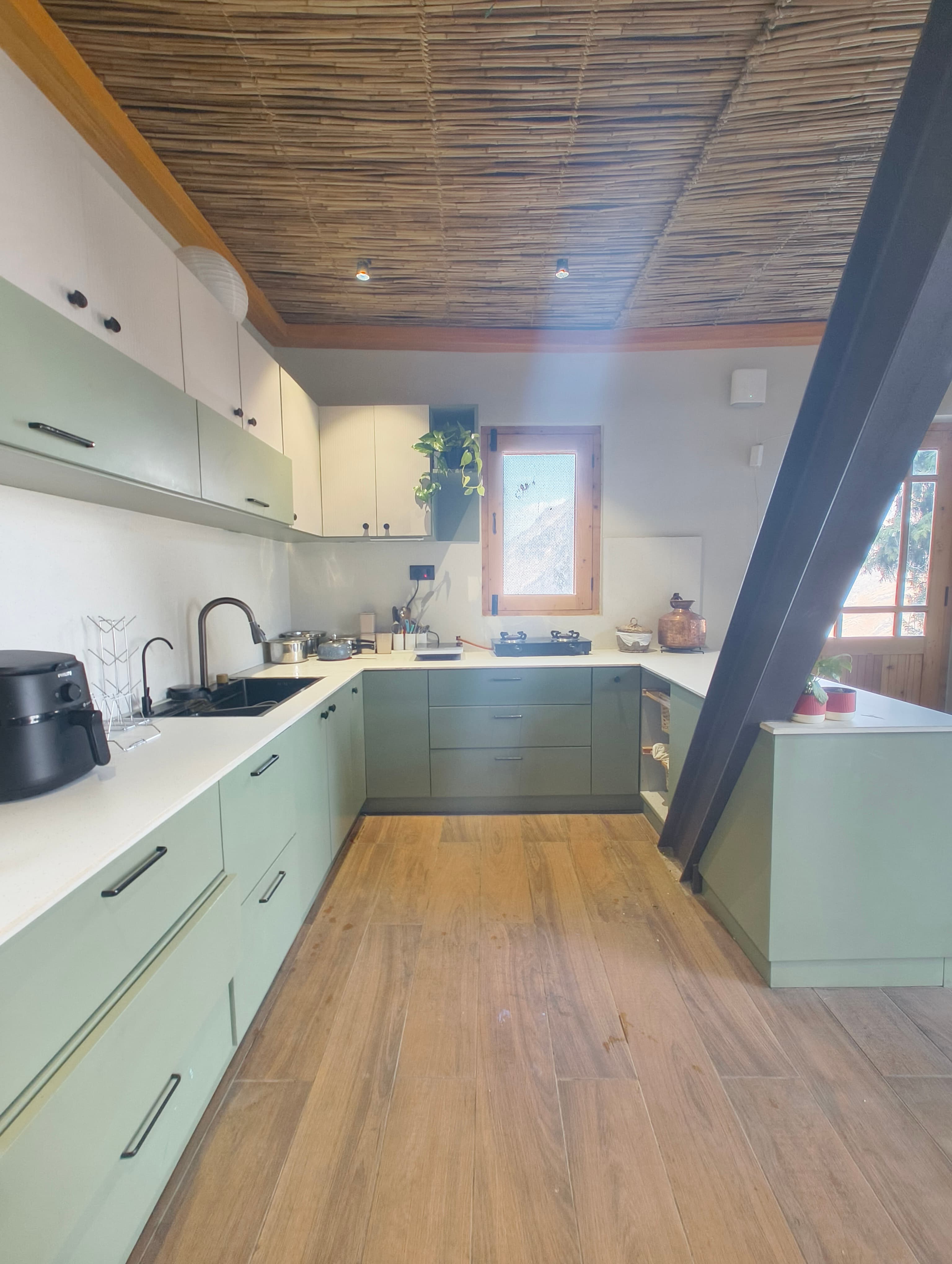 Vaadi kitchen — sage green cabinets, bamboo ceiling
